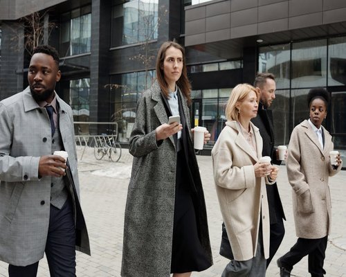 group of people walking and talking in the city
